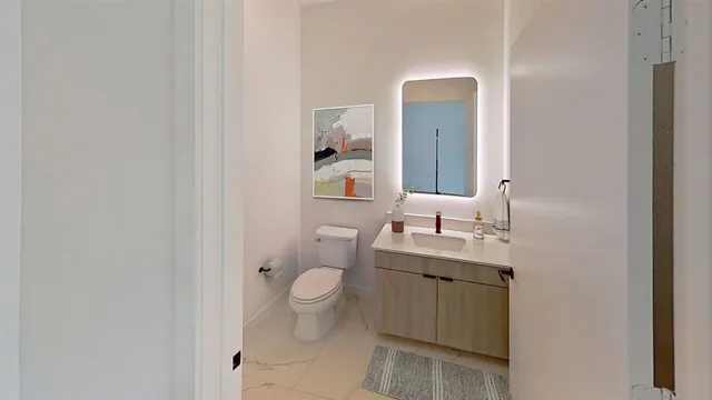 a bathroom with a toilet a sink and mirror