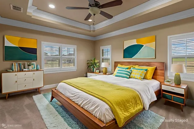 a bedroom with a bed and a flat tv screen on dresser