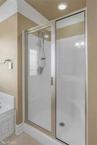 a bathroom with a glass shower door and a toilet