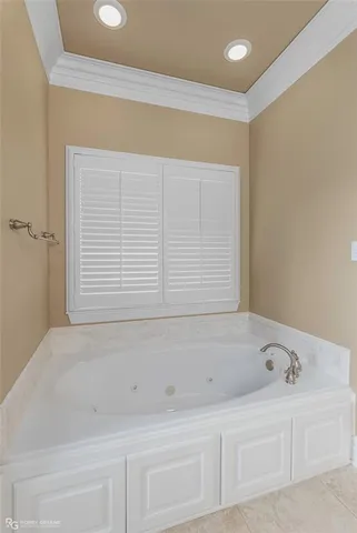 a bathroom with a bathtub and next to a window