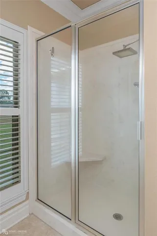 a bathroom with a glass shower door