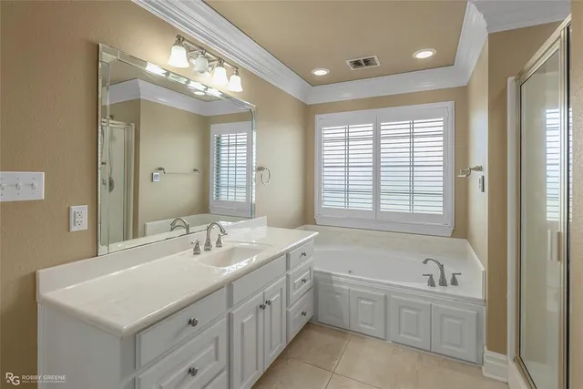 a bathroom with a double vanity sink a mirror and a bathtub
