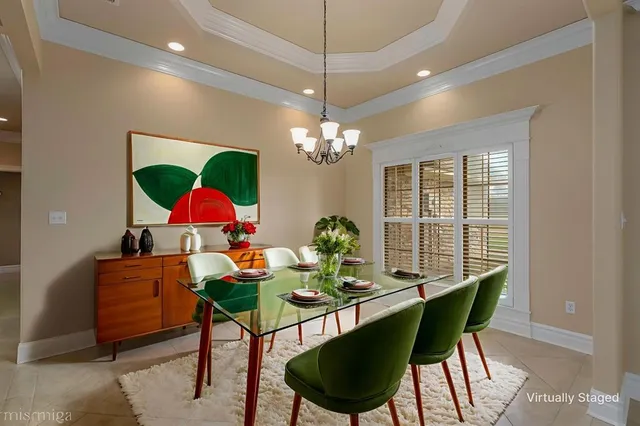 a view of a dining room with furniture and chandelier