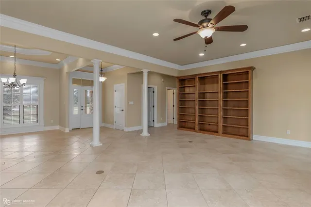 a view of an empty room with a ceiling fan