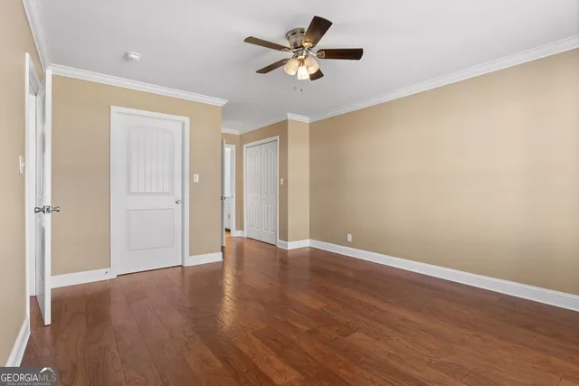 a view of an empty room with wooden floor
