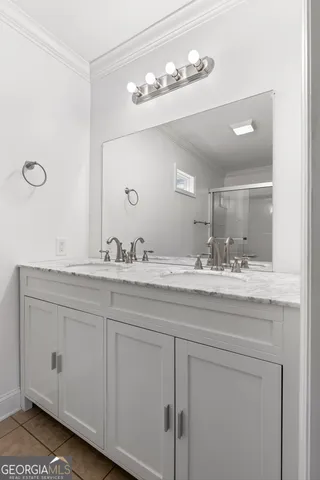 a bathroom with a granite countertop sink a mirror and vanity