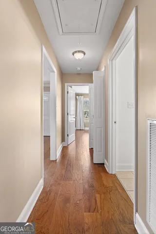a view of hallway with wooden floor