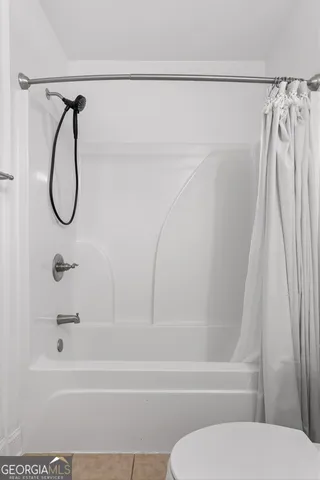 a bathroom with a shower and a shower
