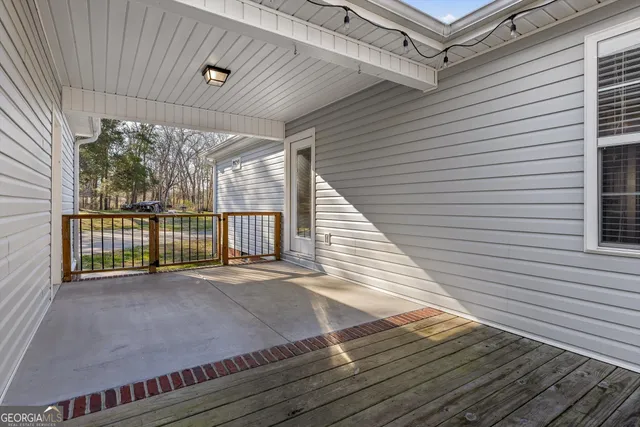 a view of a deck with wooden floor and a backyard space