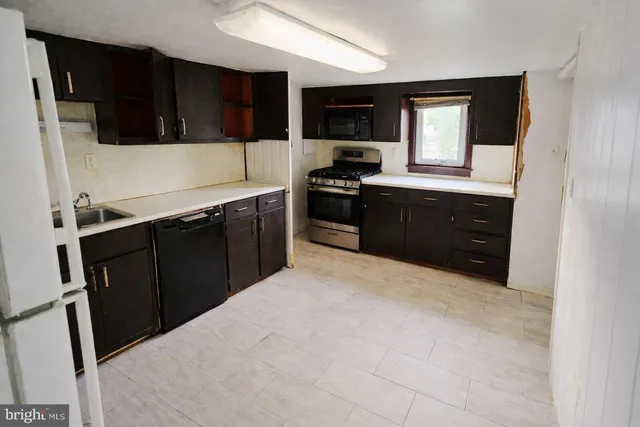 a kitchen with a sink a stove and microwave