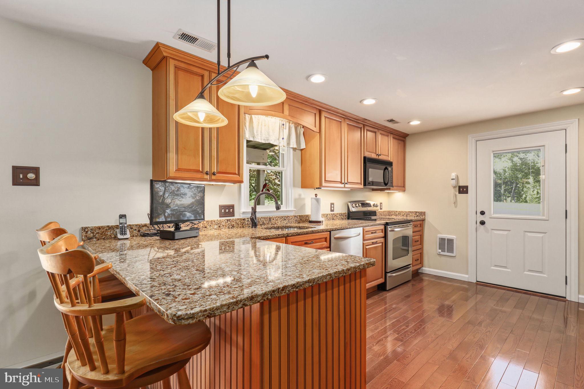 6336 Boyers Mill Road New Market, MD 21774 - Photo 9 of 49 a kitchen with granite countertop a sink cabinets and stainless steel appliances