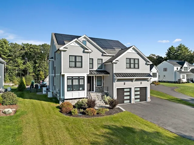 a front view of a house with a yard and garage