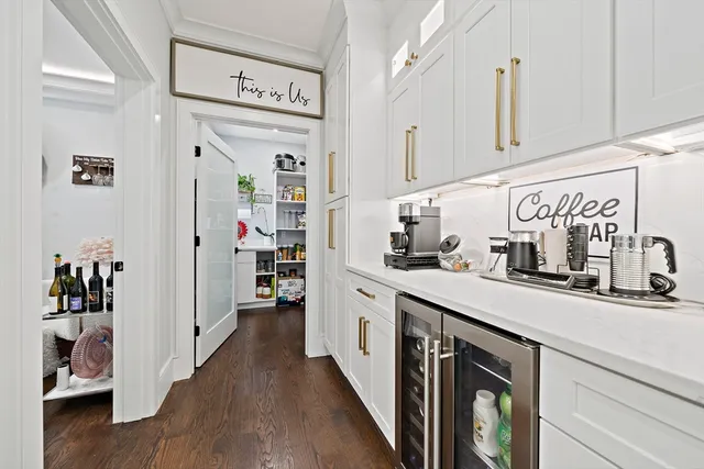 a kitchen with a sink cabinets and wooden floor