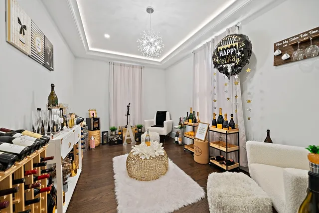 a living room with furniture and a chandelier
