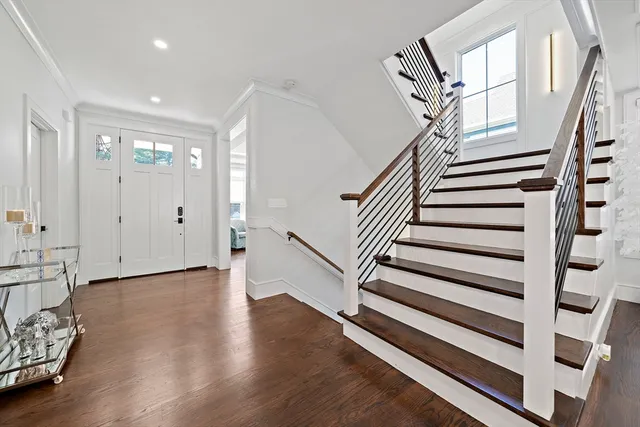 a view of entryway with wooden floor and stairs