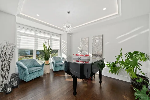 a dining room with furniture potted plants and wooden floor