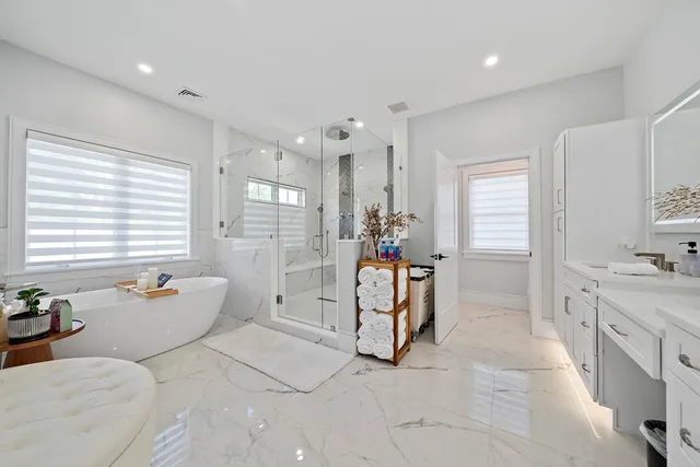 a bathroom with a tub sink and mirror