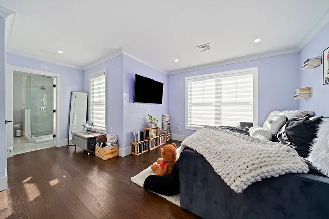 a bedroom with two beds and a flat screen tv