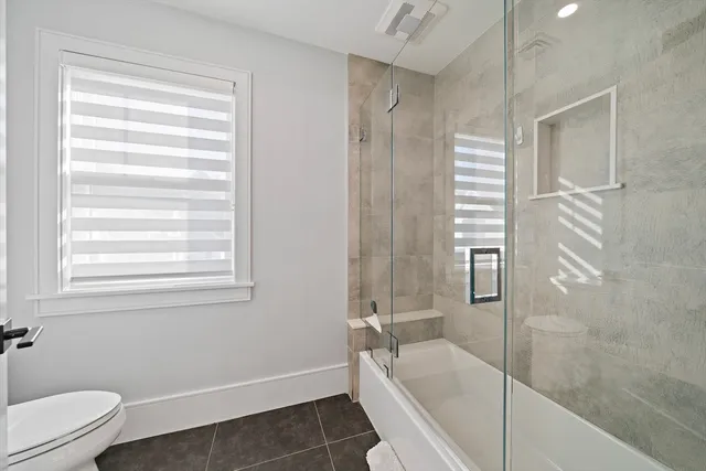 a bathroom with a bathtub and a shower
