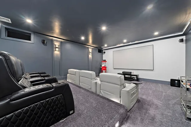 a living room with furniture a projector and a projector