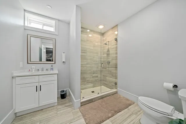 a bathroom with a toilet a sink and shower