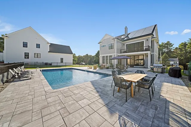 a view of a swimming pool with outdoor seating