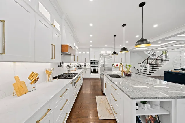 a kitchen with stainless steel appliances granite countertop a stove a sink and a refrigerator