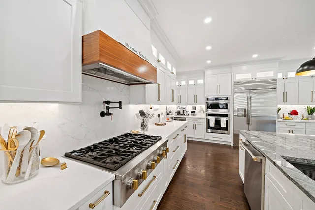 a kitchen with stove and refrigerator