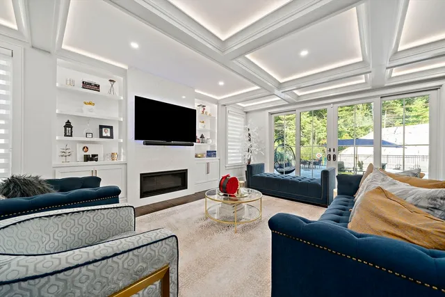 a living room with furniture a fireplace and a flat screen tv