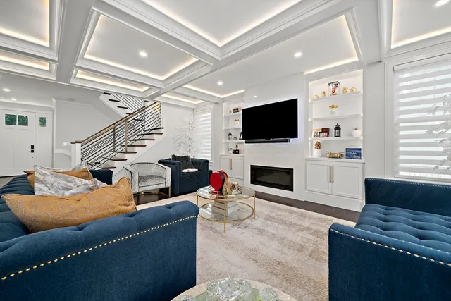 a living room with furniture a fireplace and a flat screen tv