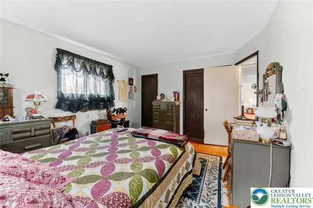 a bedroom with a bed and a painting on the wall