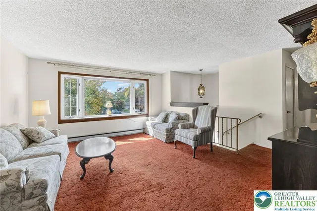 a living room with stainless steel appliances kitchen island granite countertop furniture and a view of kitchen