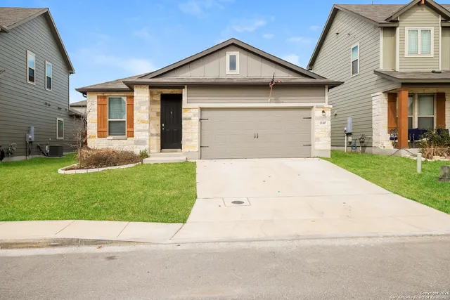 a front view of a house with a yard and garage