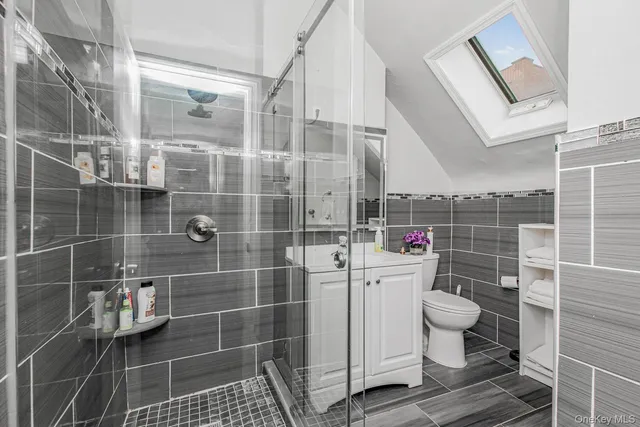 a bathroom with a toilet and a shower