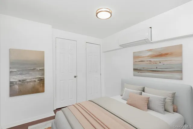 a bedroom with a bed and a painting on the wall