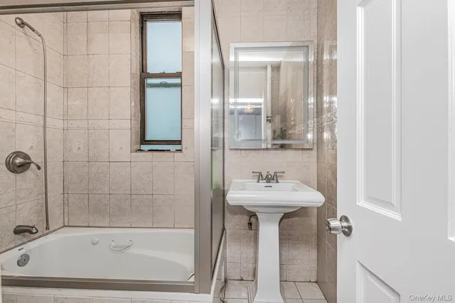 a bathroom with a sink a mirror and a bathtub