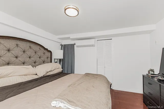 a bedroom with a bed and a television