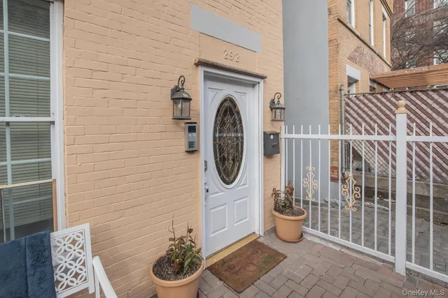 a floor to ceiling window and a potted plant