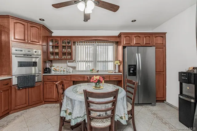 a kitchen with stainless steel appliances granite countertop a refrigerator and a stove
