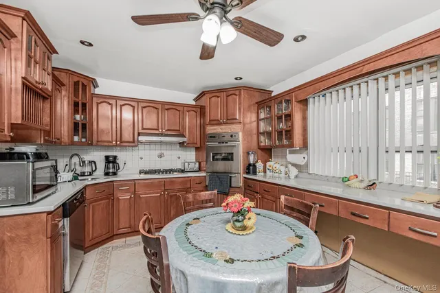 a kitchen with stainless steel appliances granite countertop a sink a stove and a refrigerator