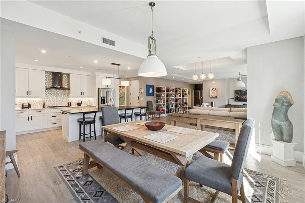 1135 3rd Avenue South, Unit 119 Naples, FL 34102 - Photo 12 of 50 a living room with stainless steel appliances kitchen island granite countertop furniture and a kitchen view