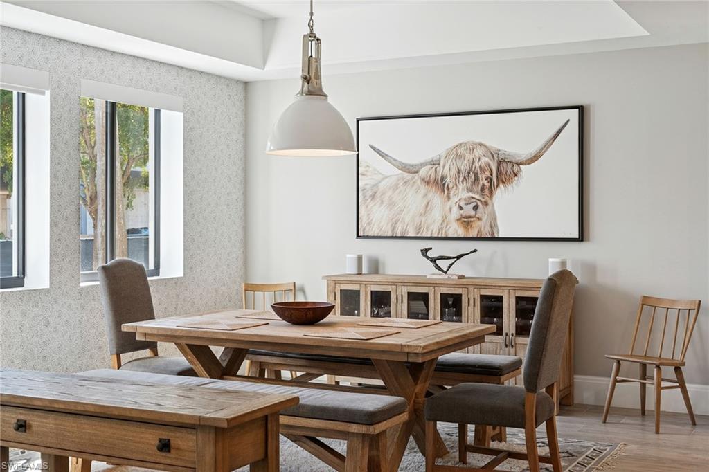 1135 3rd Avenue South, Unit 119 Naples, FL 34102 - Photo 14 of 50 a living room with furniture and a painting on the wall