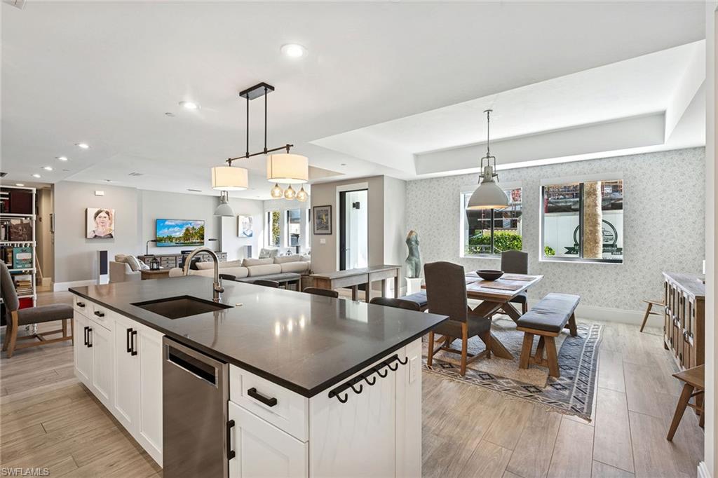 1135 3rd Avenue South, Unit 119 Naples, FL 34102 - Photo 17 of 50 a kitchen with stainless steel appliances granite countertop a sink counter top space and living room view