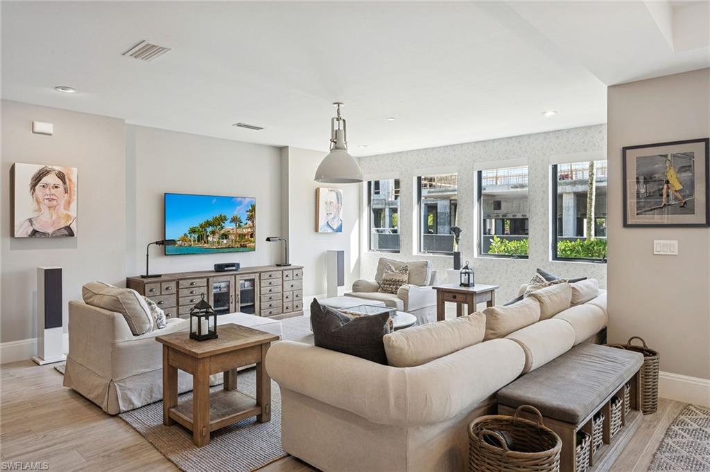 1135 3rd Avenue South, Unit 119 Naples, FL 34102 - Photo 19 of 50 a living room with furniture and a flat screen tv