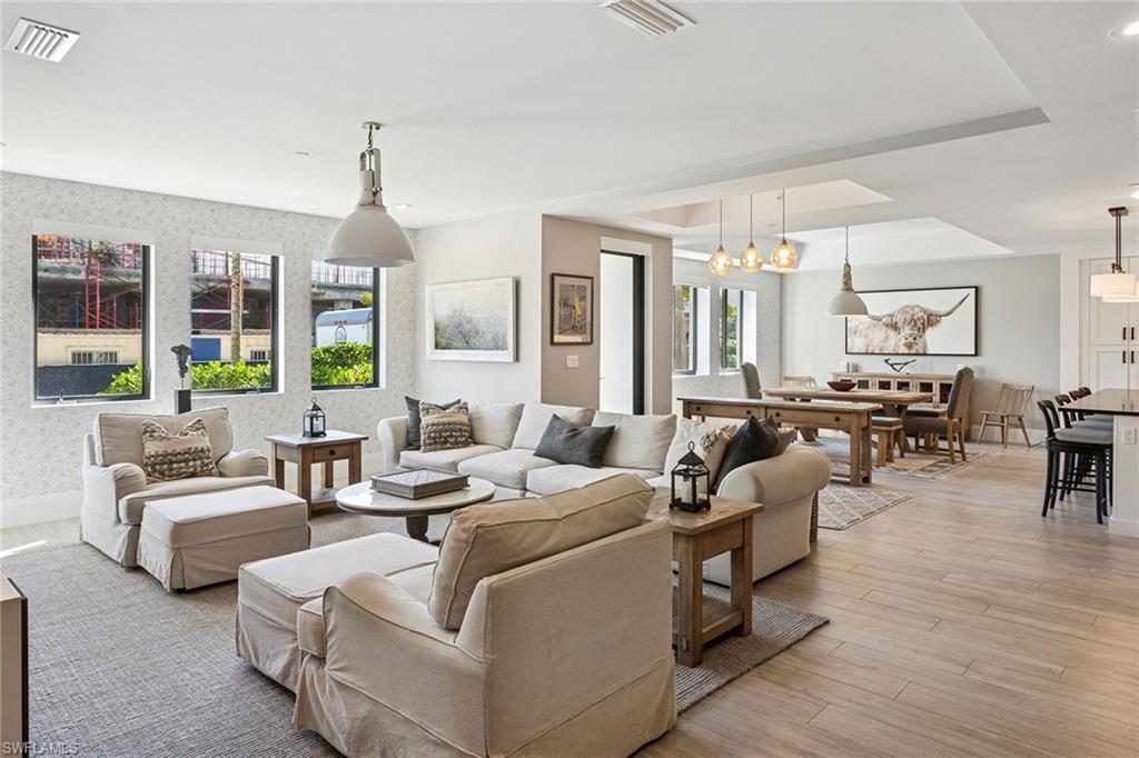 1135 3rd Avenue South, Unit 119 Naples, FL 34102 - Photo 20 of 50 a living room with furniture kitchen view and large windows