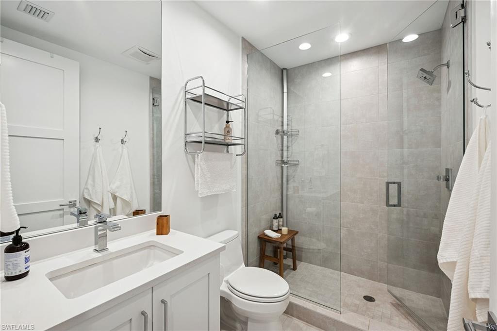 1135 3rd Avenue South, Unit 119 Naples, FL 34102 - Photo 26 of 50 a bathroom with a sink a toilet and shower