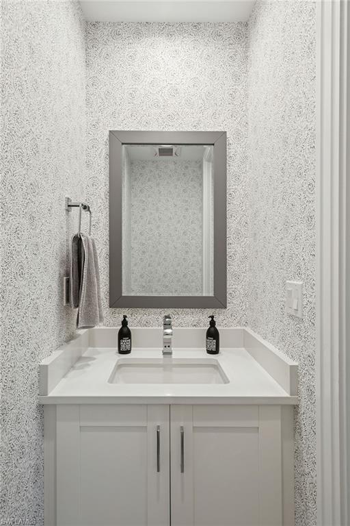 1135 3rd Avenue South, Unit 119 Naples, FL 34102 - Photo 27 of 50 a bathroom with a sink and a mirror