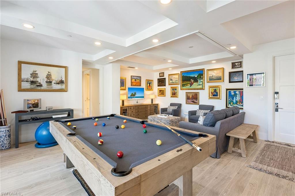 1135 3rd Avenue South, Unit 119 Naples, FL 34102 - Photo 30 of 50 a living room with furniture pool table and a large window