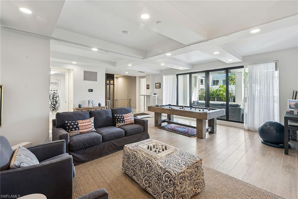 1135 3rd Avenue South, Unit 119 Naples, FL 34102 - Photo 34 of 50 a living room with furniture and a large window