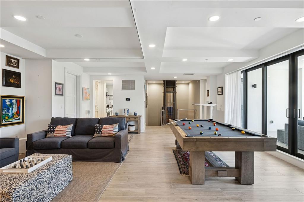 1135 3rd Avenue South, Unit 119 Naples, FL 34102 - Photo 35 of 50 a living room with furniture a table and a large window